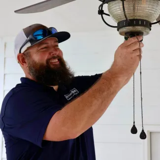 CrewPros employee changing a fixture.