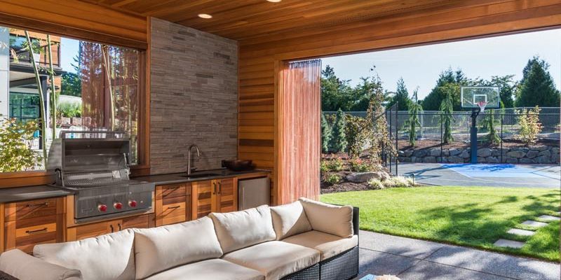 Custom outdoor patio with a grill and sitting space.